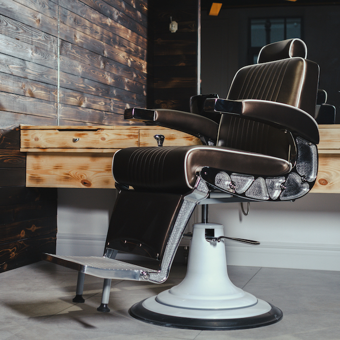Stylish Vintage Barber Chair In Wooden Interior. Barbershop Theme